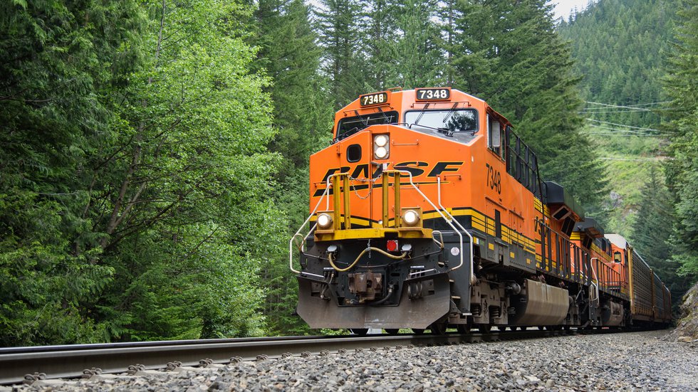 Those are the Cascade Mountains in Washington this BNSF freight train is passing through.